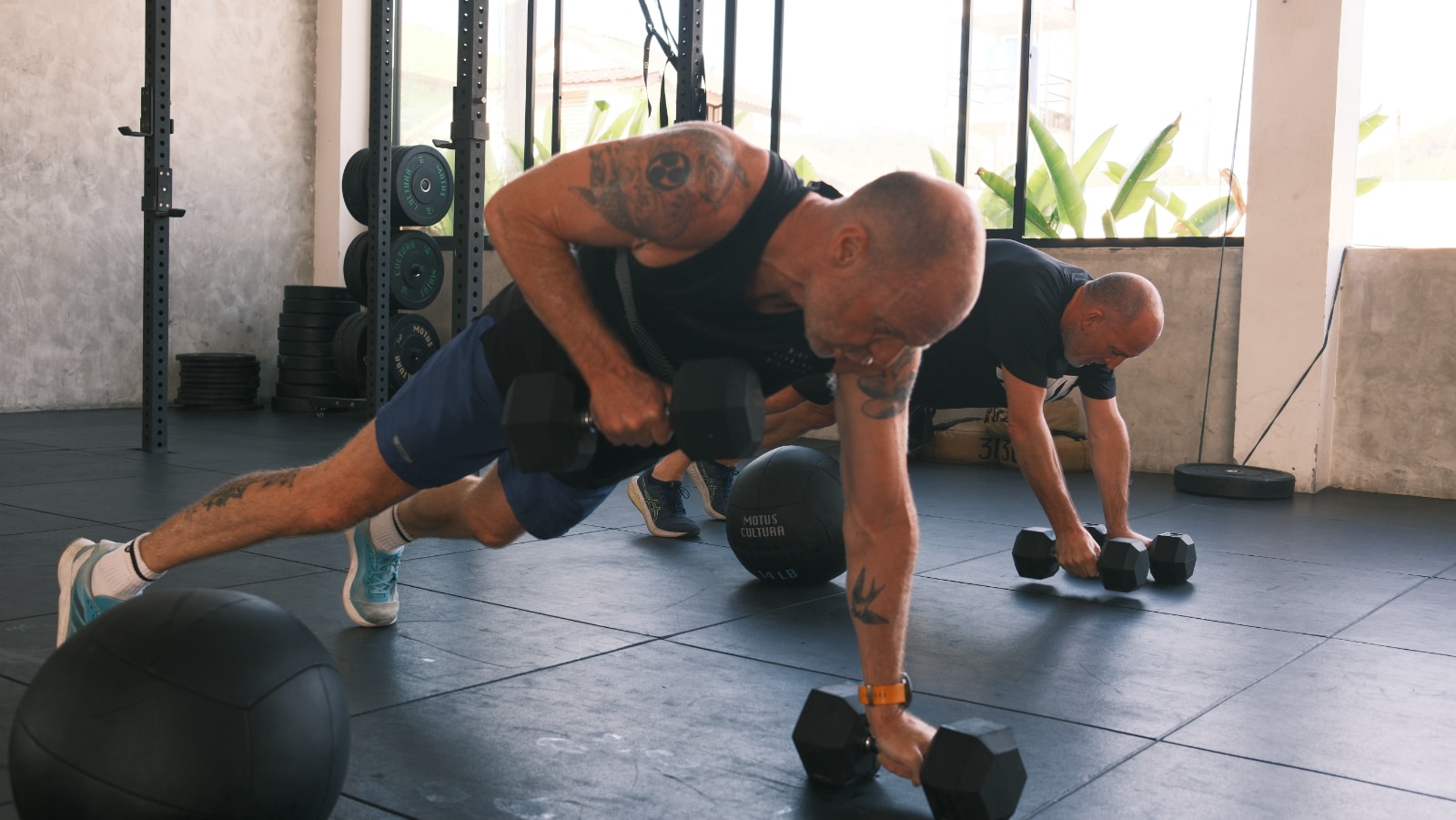 Athletes training with dumbbells during Sweat class