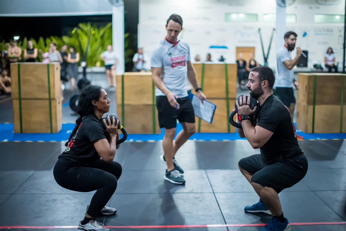 Wall ball squats with judges