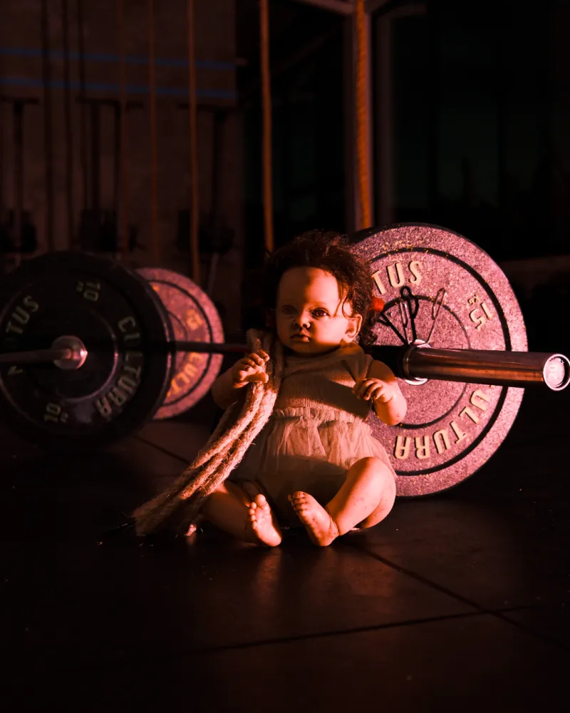 Doll sitting by a barbell with a long rope, Workout 3 art